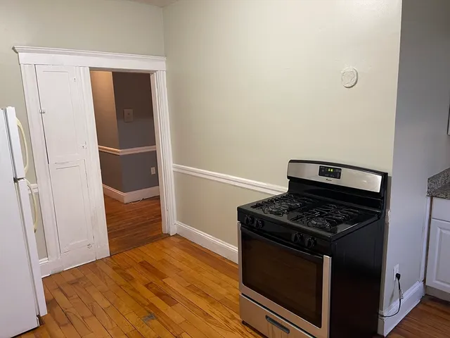 a kitchen with granite countertop a stove and a refrigerator
