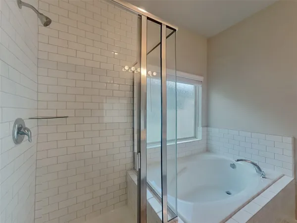 a bathroom with a bathtub and shower