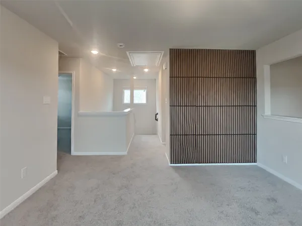 a view of an empty room and a window