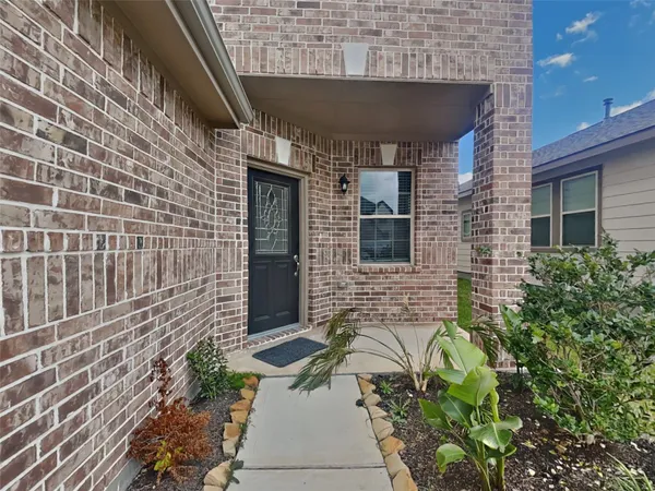 a brick building with a bench in front