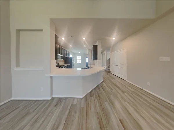a view of kitchen and wooden floor