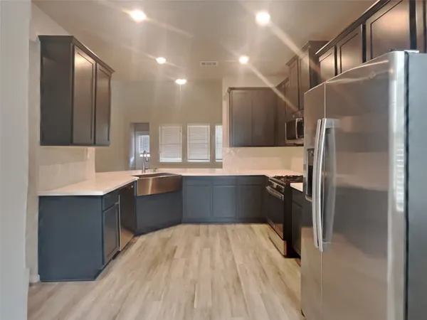 a kitchen with a refrigerator and a sink