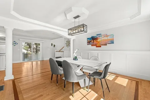 a view of a dining room with furniture and wooden floor