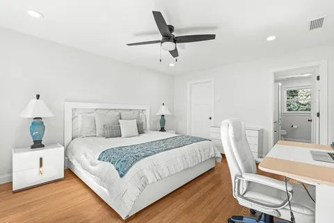 a bedroom with a bed a table and chair