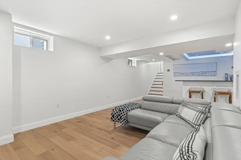 a living room with furniture and a ceiling fan
