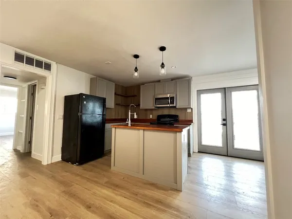 a kitchen with stainless steel appliances a refrigerator stove microwave and sink