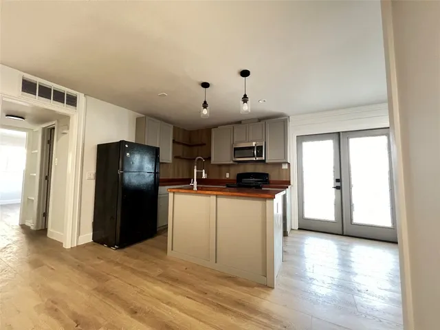 a kitchen with stainless steel appliances a refrigerator stove microwave and sink