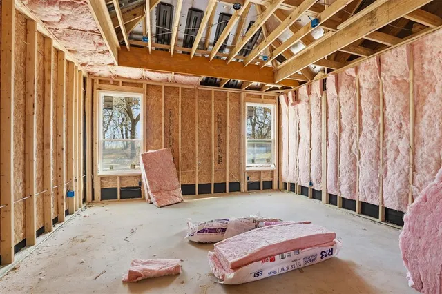 a bedroom with furniture and large window