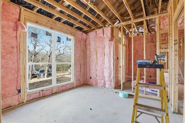 a view of a room with wooden floor and windows