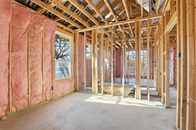 a view of a room with wooden walls and windows