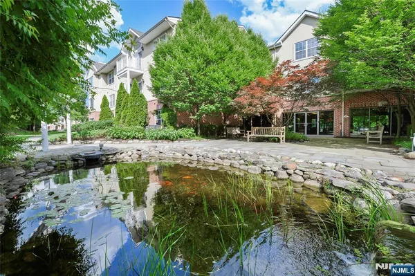 a swimming pool with outdoor seating and trees