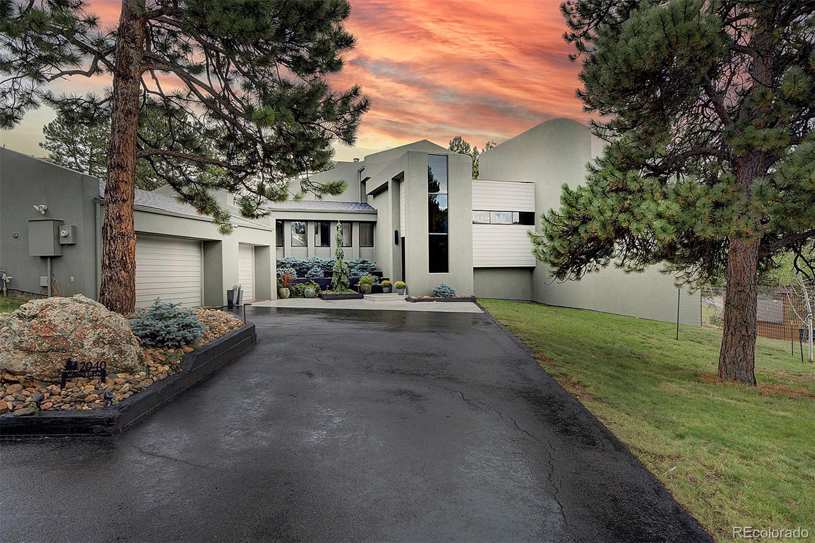 2040 Werner Lane Evergreen, CO 80439 - Photo 1 of 47 a front view of a house with a garden and yard