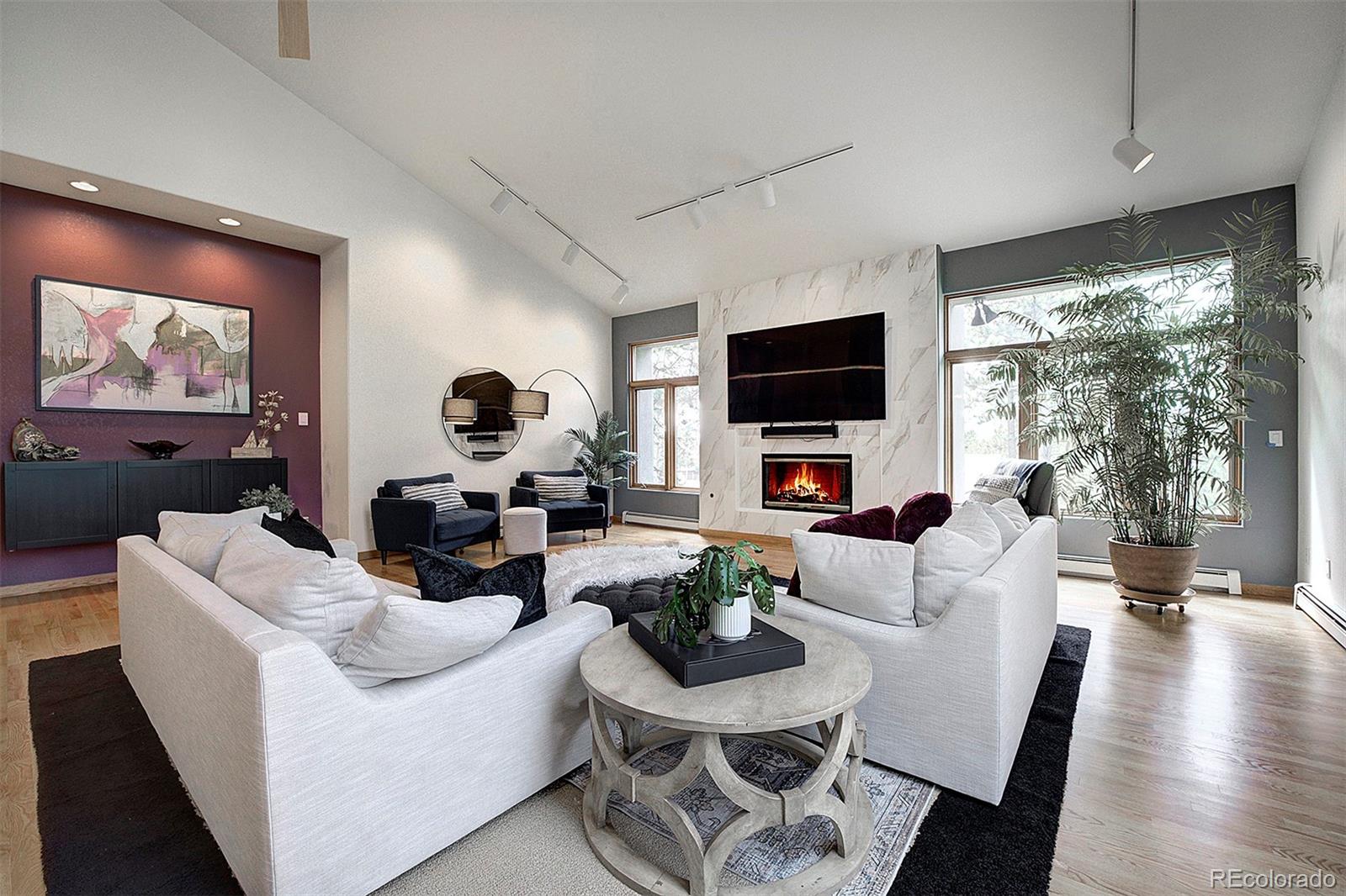 2040 Werner Lane Evergreen, CO 80439 - Photo 11 of 47 a living room with furniture a flat screen tv and a large window