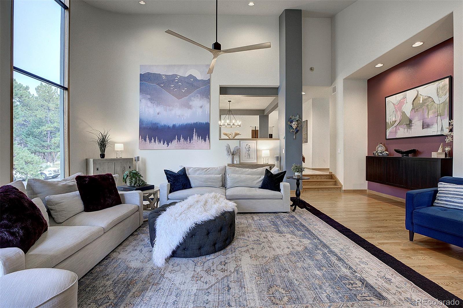 2040 Werner Lane Evergreen, CO 80439 - Photo 12 of 47 a living room with furniture two large window and a flat screen tv