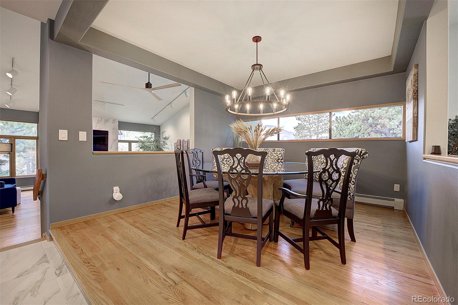 2040 Werner Lane Evergreen, CO 80439 - Photo 15 of 47 a view of a dining room with furniture a chandelier and wooden floor