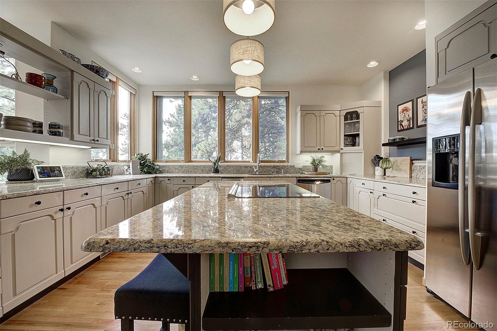 2040 Werner Lane Evergreen, CO 80439 - Photo 16 of 47 a kitchen with stainless steel appliances granite countertop a stove top oven a sink dishwasher and white cabinets with wooden floor