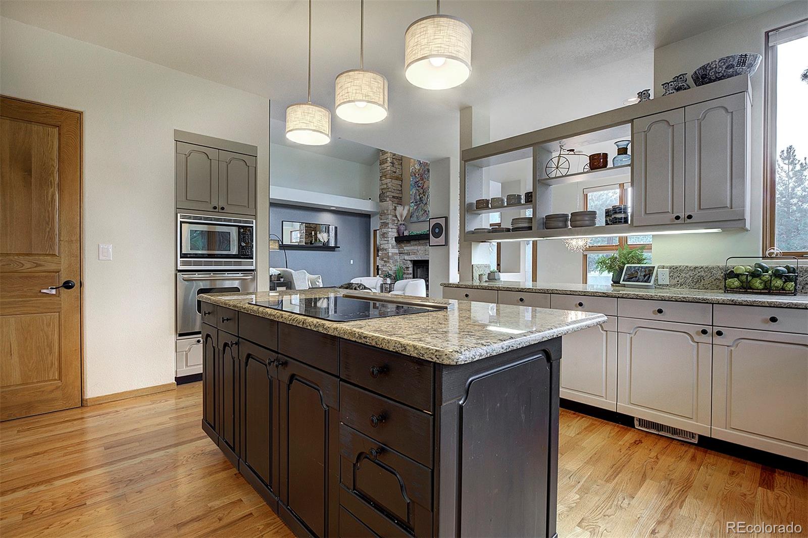 2040 Werner Lane Evergreen, CO 80439 - Photo 17 of 47 a kitchen with stainless steel appliances granite countertop a sink a stove and a wooden floors