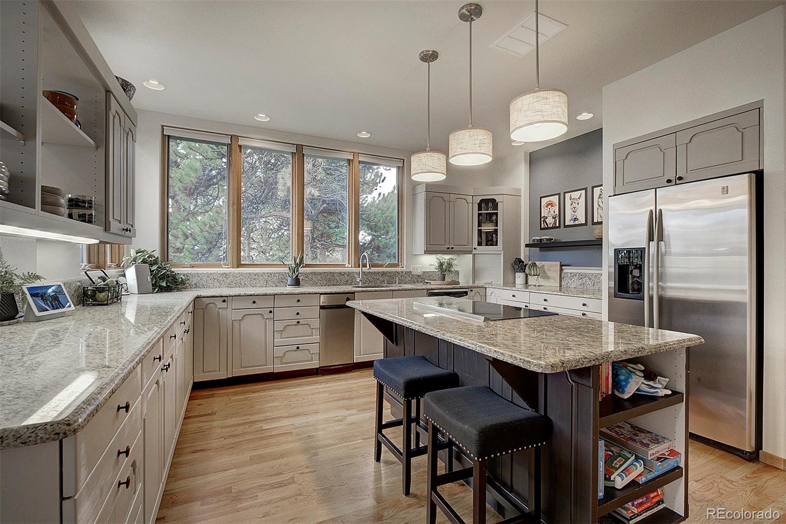2040 Werner Lane Evergreen, CO 80439 - Photo 19 of 47 a large kitchen with granite countertop a sink a center island stainless steel appliances and cabinets