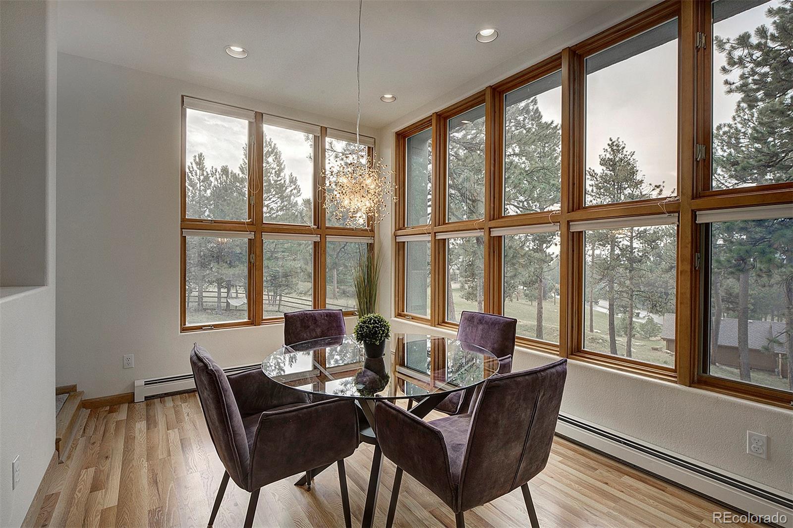2040 Werner Lane Evergreen, CO 80439 - Photo 21 of 47 a view of a dining room with furniture large windows and wooden floor