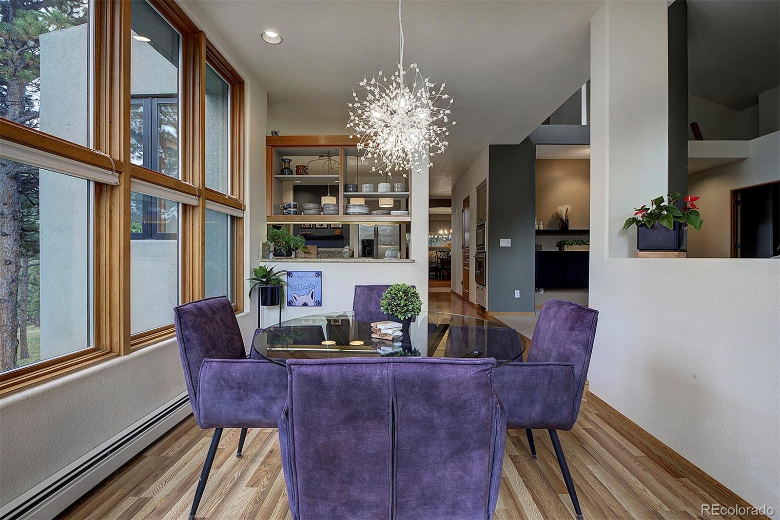 2040 Werner Lane Evergreen, CO 80439 - Photo 22 of 47 a view of a dining room with furniture window and wooden floor