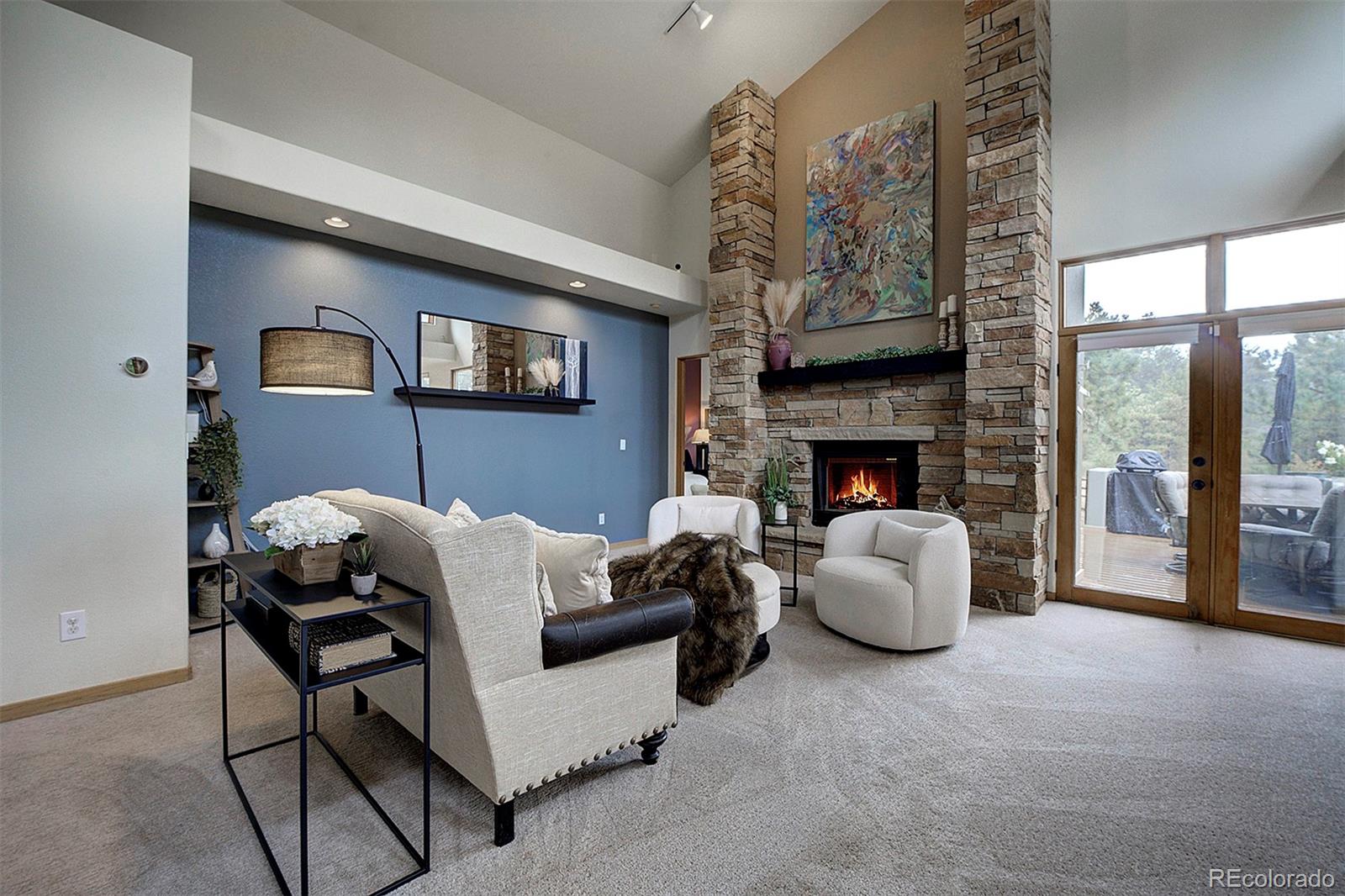 2040 Werner Lane Evergreen, CO 80439 - Photo 24 of 47 a living room with furniture a fireplace and a large window