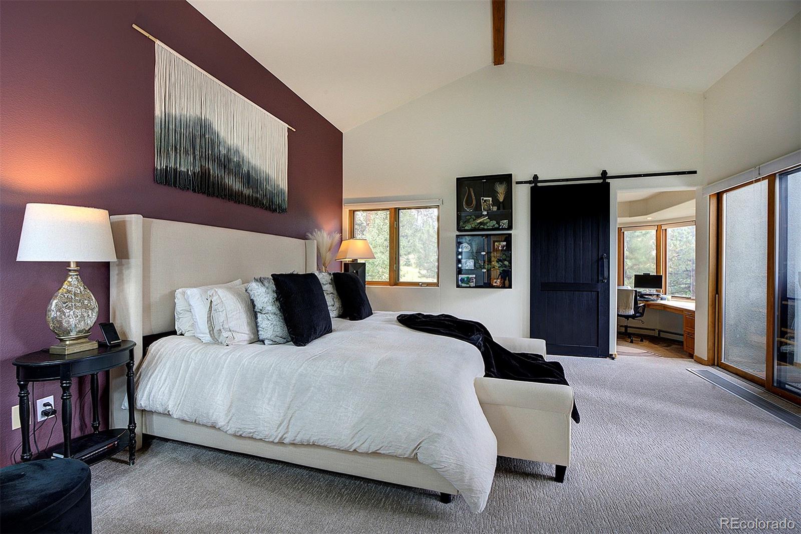 2040 Werner Lane Evergreen, CO 80439 - Photo 27 of 47 a bedroom with a bed and a large mirror