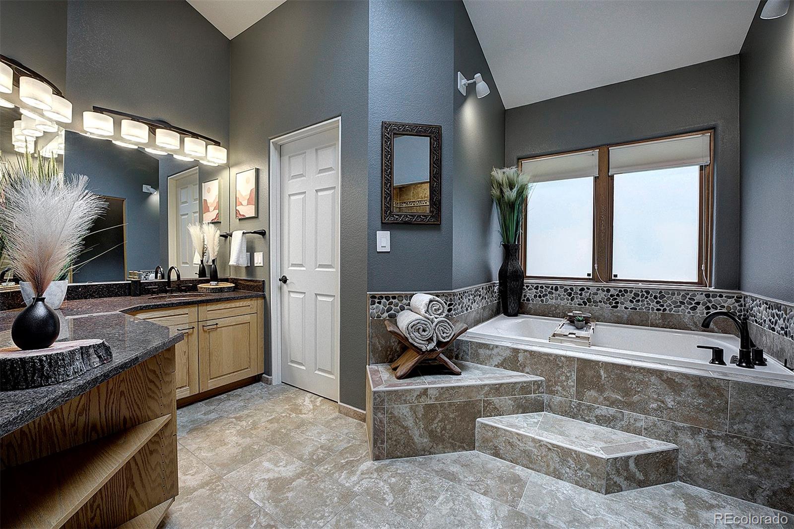 2040 Werner Lane Evergreen, CO 80439 - Photo 31 of 47 a spacious bathroom with a tub a double vanity sink and mirror