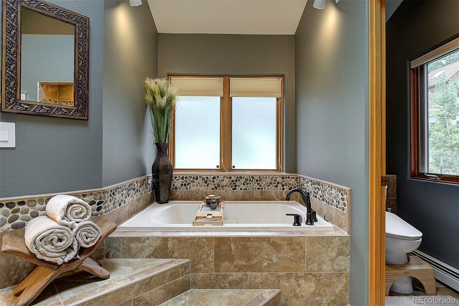 2040 Werner Lane Evergreen, CO 80439 - Photo 32 of 47 a bathroom with a bathtub and a window