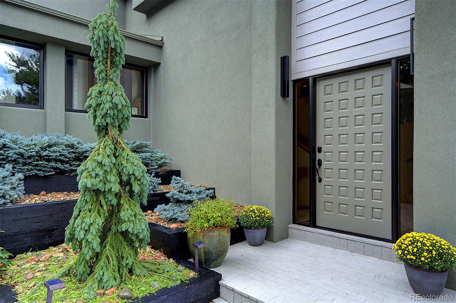 2040 Werner Lane Evergreen, CO 80439 - Photo 5 of 47 a front view of a house with lots of potted plants