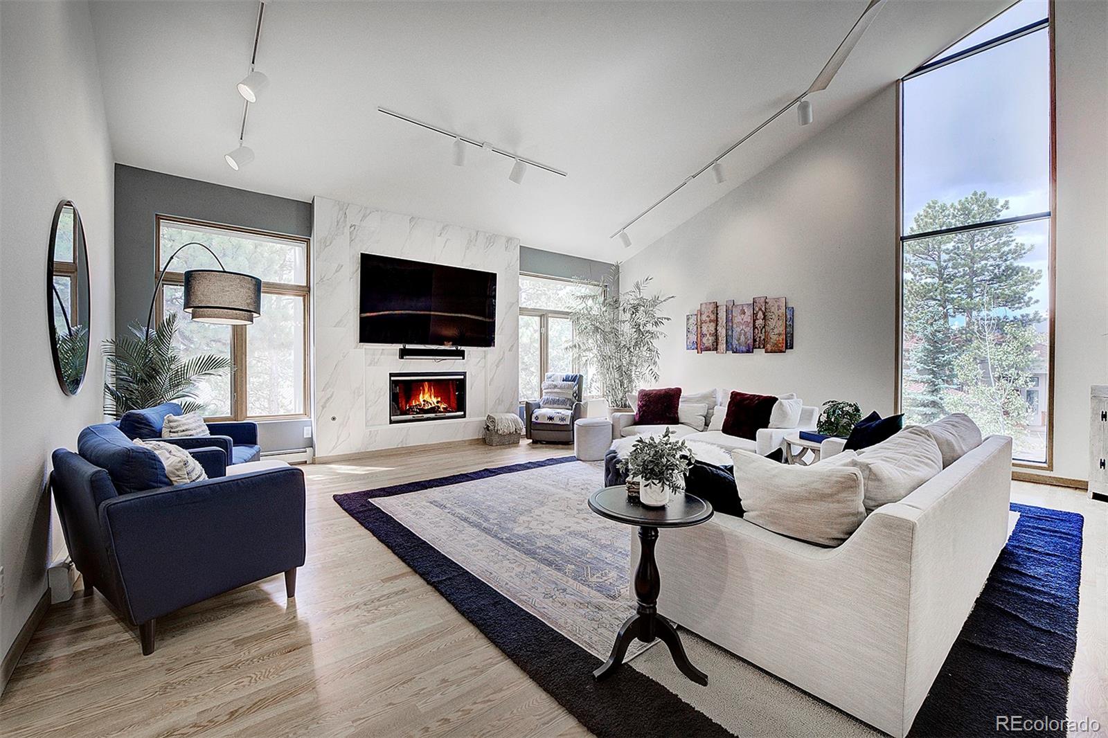2040 Werner Lane Evergreen, CO 80439 - Photo 10 of 47 a living room with furniture fireplace and a flat screen tv