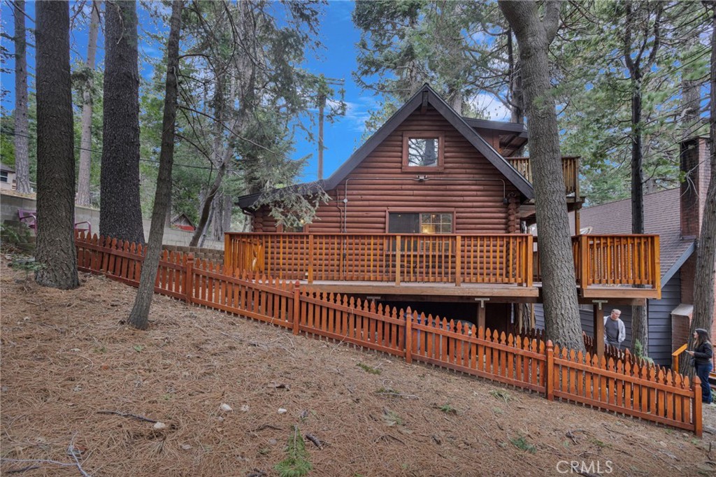 788 Buckingham Square Lake Arrowhead, CA 92352 - Photo 43 of 61 a view of a house with a small yard and wooden deck