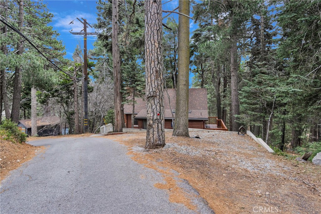 788 Buckingham Square Lake Arrowhead, CA 92352 - Photo 56 of 61 a view of a house with large trees and covered with snow in the background