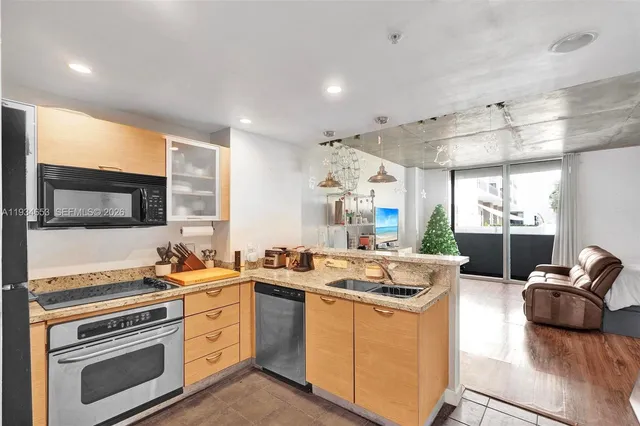 a kitchen that has a sink and a stove top oven