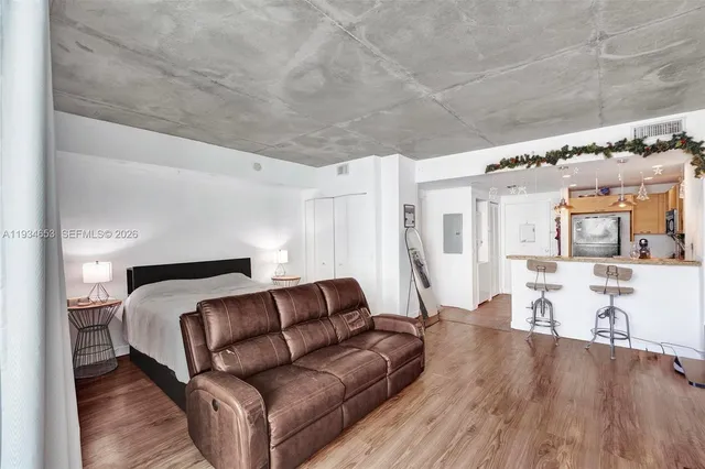 a living room with furniture and wooden floor