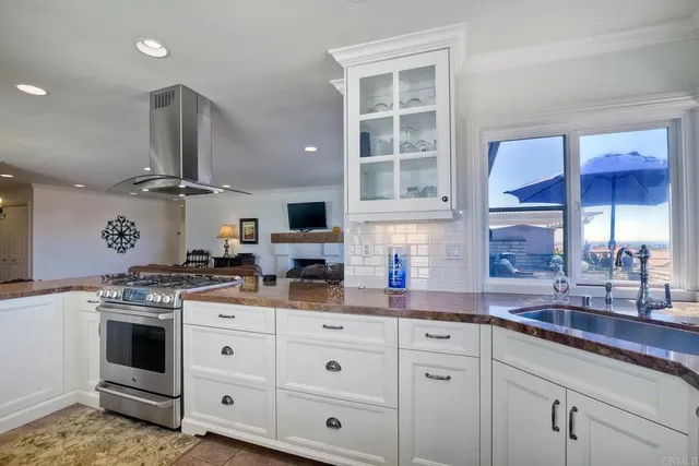 a kitchen with stainless steel appliances granite countertop a stove and a sink