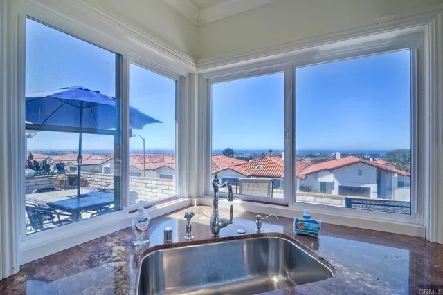 a kitchen with a sink and a large window