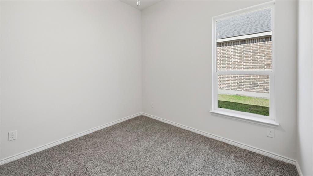 4163 Waldron Trail Forney, TX 75126 - Photo 24 of 30 Bright interior space featuring a window with white trim, gray plush carpeting, white baseboards, and neutral wall paint