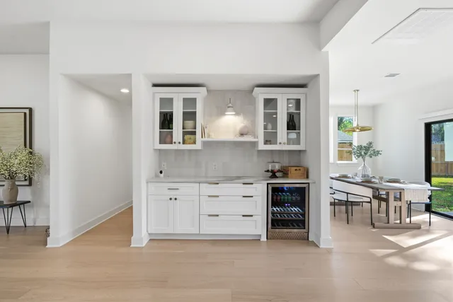 a kitchen with cabinets and chairs