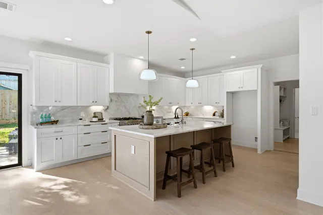 a kitchen with a sink stove and refrigerator