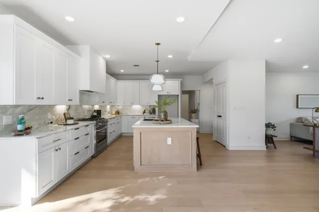 a large white kitchen with lots of counter space