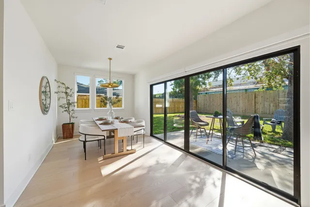 a dining room with furniture and a large window