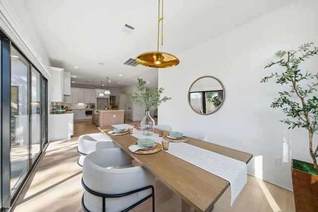 a view of a dining room with furniture wooden floor and a chandelier
