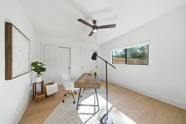 a workspace room with furniture and a potted plant