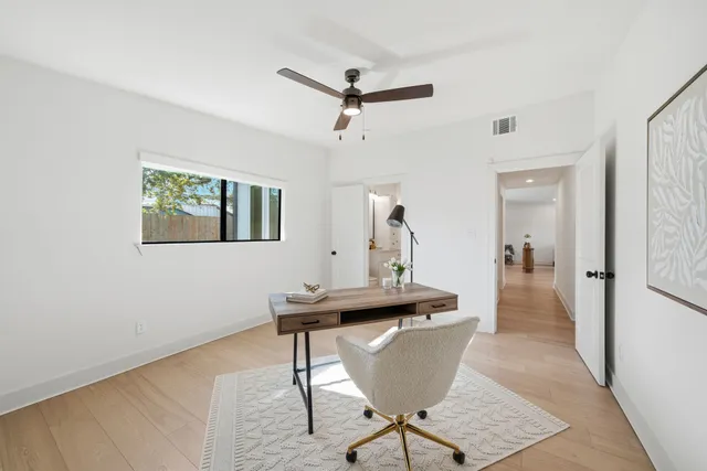 a view of a room with a table and chairs