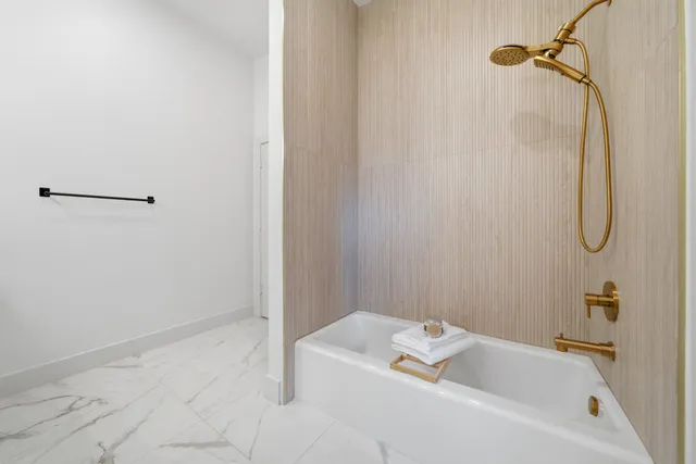 a bathroom with a tub and a shower