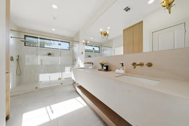 a large white kitchen with a large window