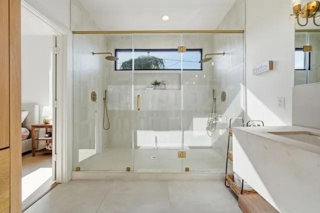 a bathroom with a granite countertop sink a shower and a mirror