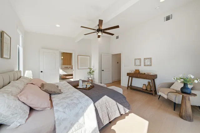 a bedroom with a bed and a chandelier