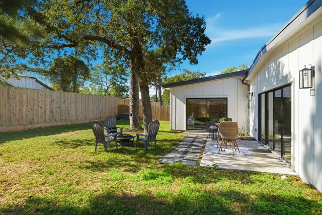 a backyard of a house with table and chairs