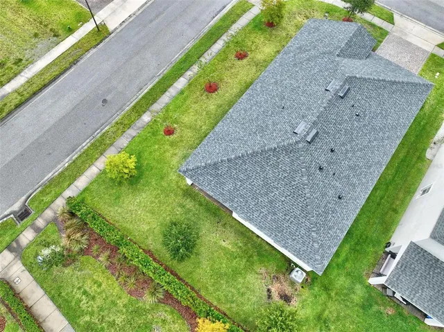 a view of a room with wooden floor and a window
